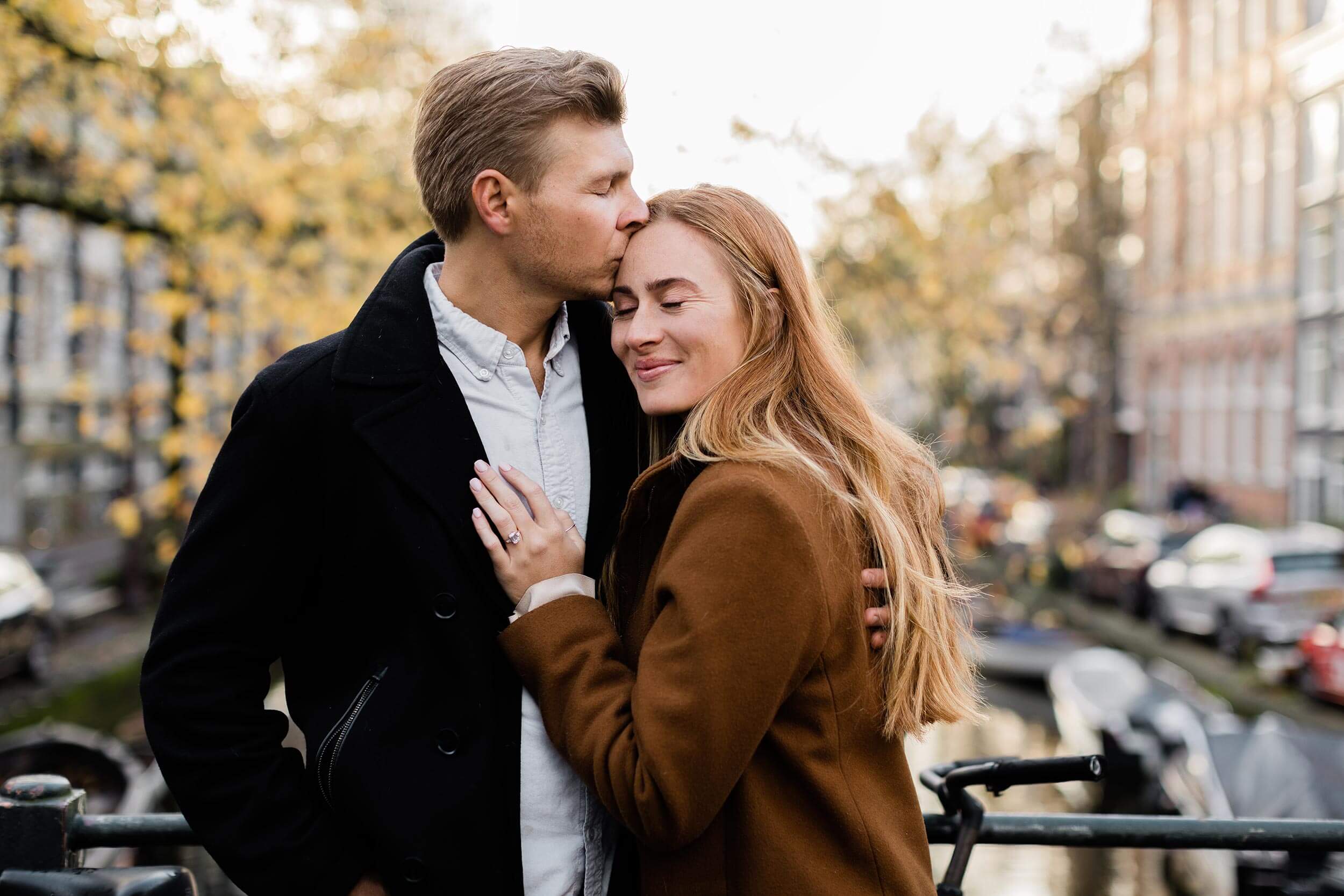 alt="lovers embrace in Amsterdam after surprise proposal in Amsterdam"