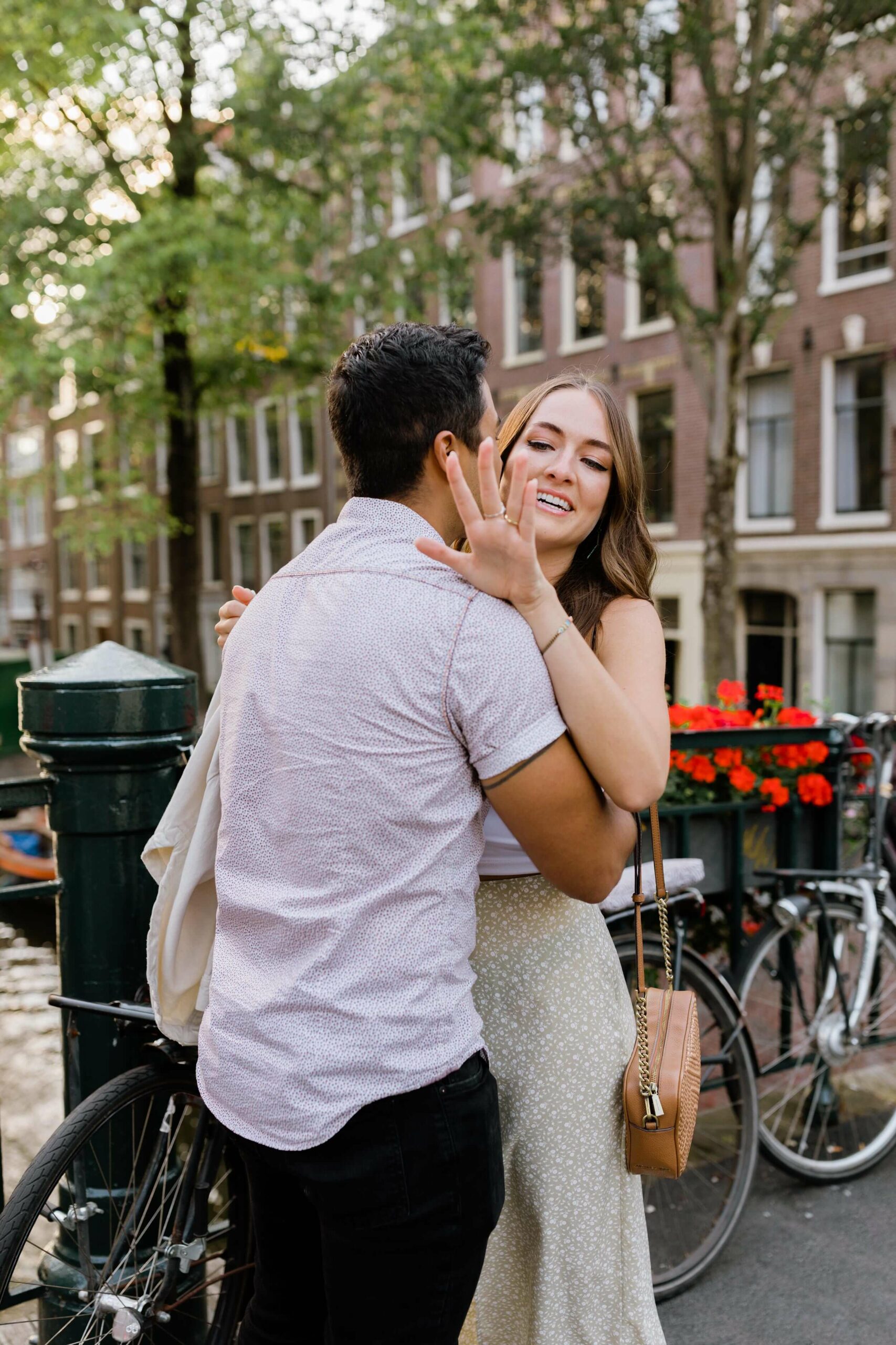alt="surprise proposal in Amsterdam next to canal"
