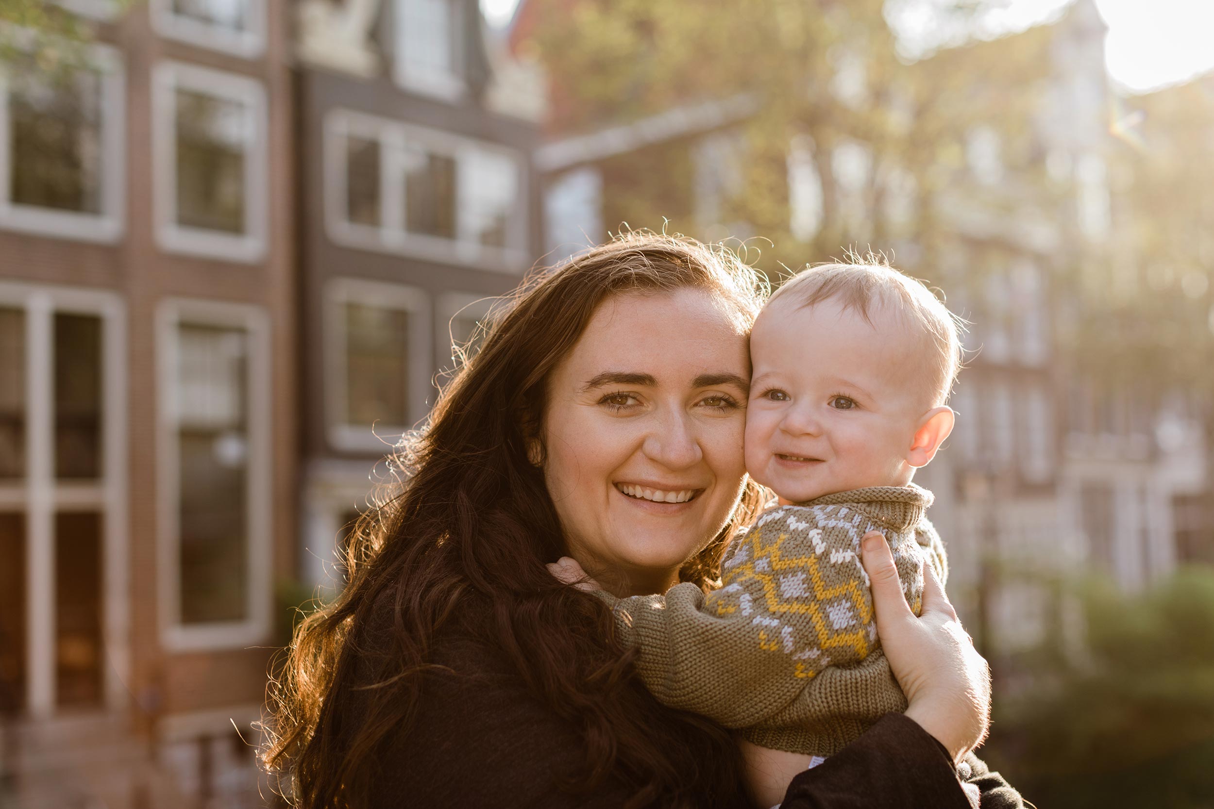 alt="Amsterdam canal view mother and baby portrait photography"